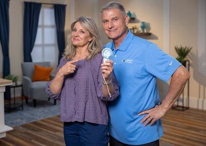 PowerHouse's Pete and Megan holding a portable fan