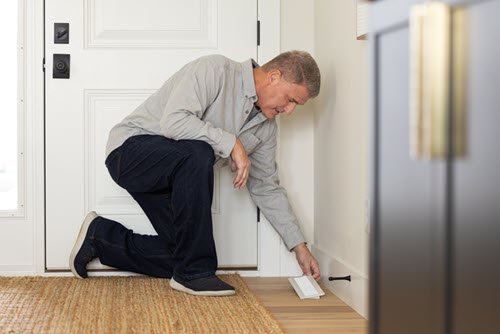a man replacing a vent cover