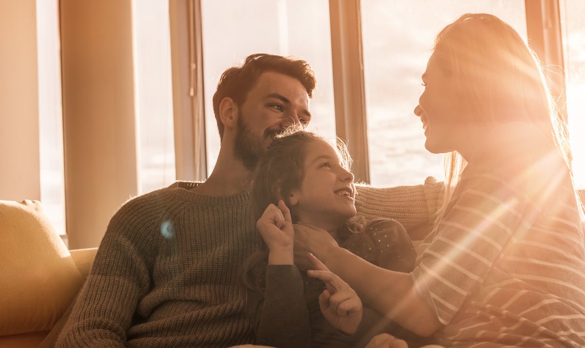 family next to a sunny window