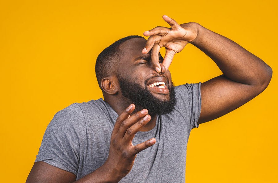 man pinching nose