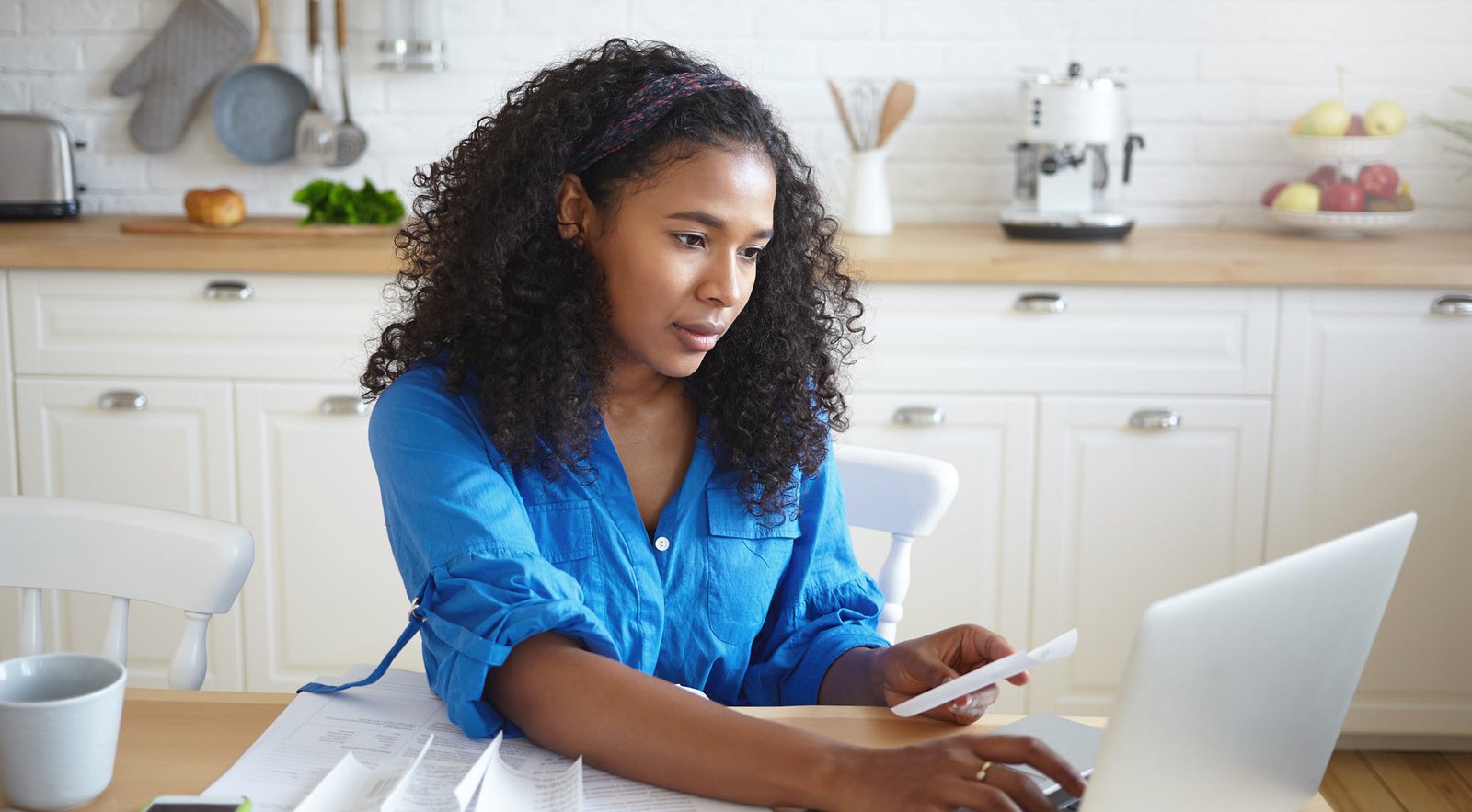 woman paying bills on a laptop