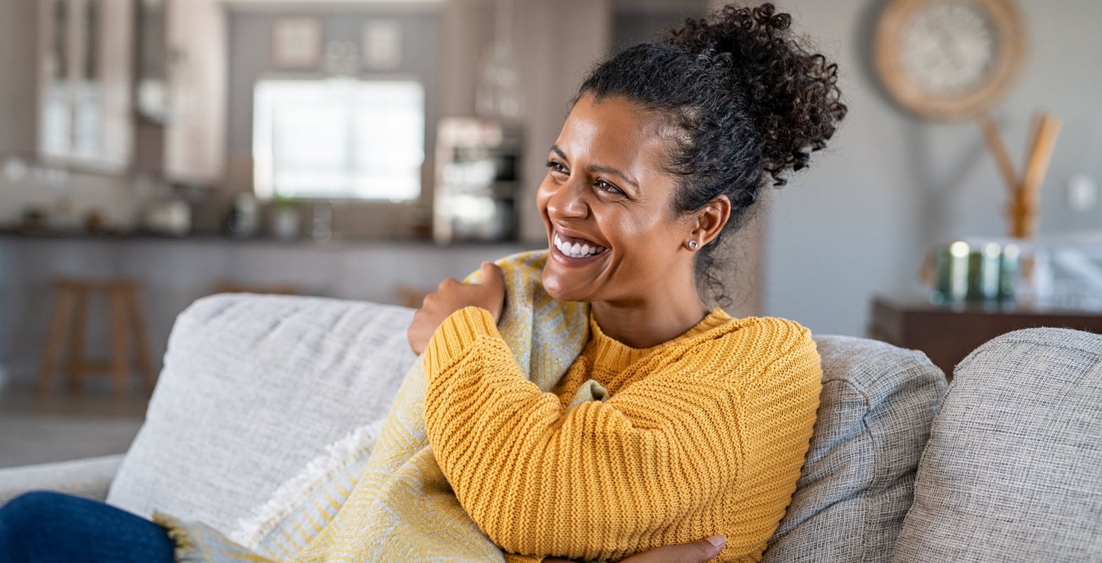 woman smiling on a couch